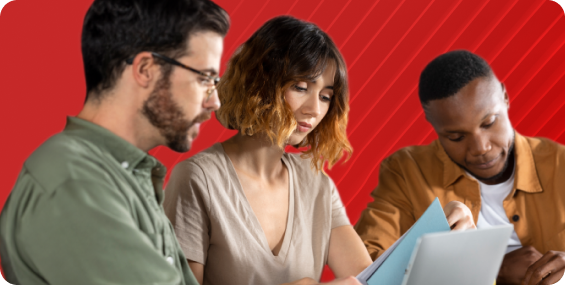 Coworkers review a sheet together in front of a stylized red background.