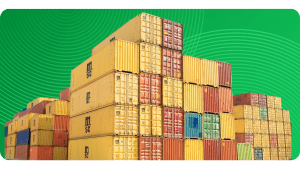 Stacks of shipping containers rest on a platform.