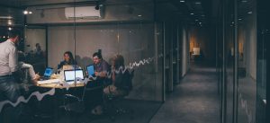 A team having a meeting inside a small conference room.
