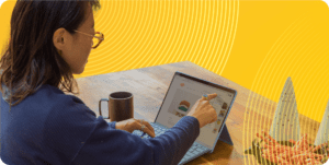 A woman working on a laptop at a table.