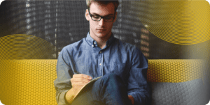 DevOps leaders sits on a yellow couch.